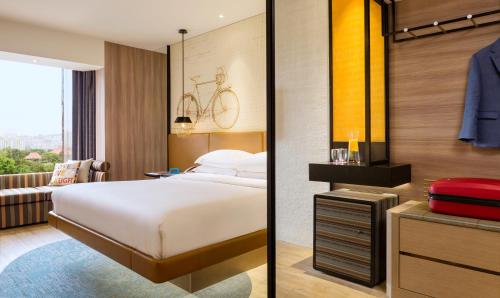 a bedroom with a bed and a bike on the wall at JEN Singapore Tanglin by Shangri-La in Singapore