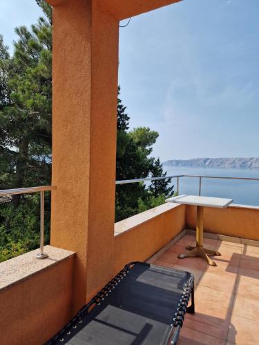 a balcony with a table and a view of the water at Blue Seagull - Seafront Holiday Home in Novi Vinodolski