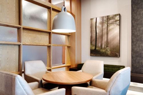 a dining room with a table and chairs at Fairfield by Marriott Inn & Suites Houston League City in League City