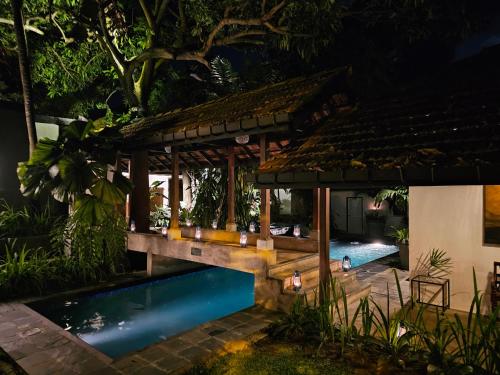 a house with a swimming pool at night at Havelock Place Bungalow in Colombo