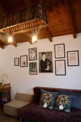 a living room with a couch and pictures on the wall at Lakeside Terrace in Neot Golan