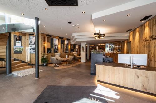 a lobby of a hotel with a reception desk at Hotel Sun Valley in Selva di Val Gardena