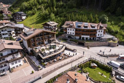 an aerial view of a town with buildings and a street at Hotel Sun Valley in Selva di Val Gardena