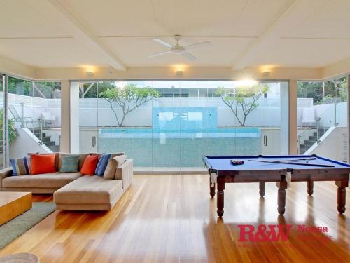 a living room with a ping pong table in it at The Beachshack, 19 The Esplanade, Sunshine Beach in Noosa Heads