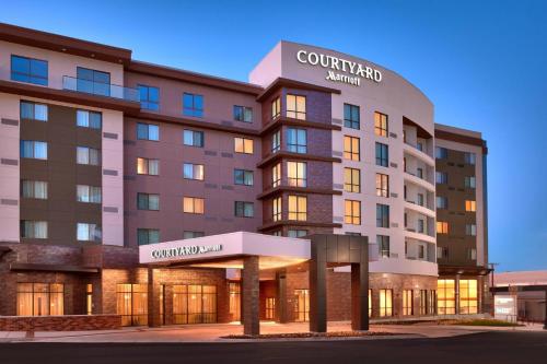 a rendering of the courtyard hotel at dusk at Courtyard by Marriott Salt Lake City Downtown in Salt Lake City