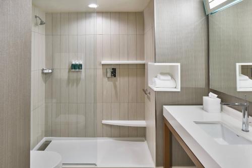 a bathroom with a shower and a sink at Courtyard Baltimore Downtown/McHenry Row in Baltimore