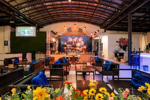 a large room with tables and chairs and a stage at Lbn Asian Hotel in Kampong Cham