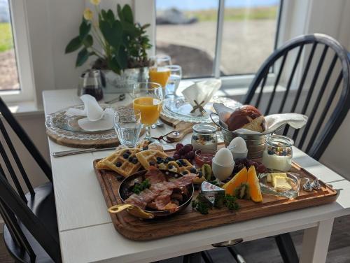 a table with a breakfast plate of food on it at Autumn Lane B&B, Farmhouse Elegance & Stunning Lakeviews in West Kelowna