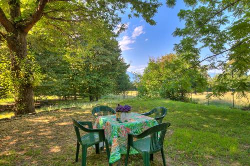 a table in a park with a table cloth on it at Villa Il Castagno Few Min From Beach - Happy Rentals in Castelveccana
