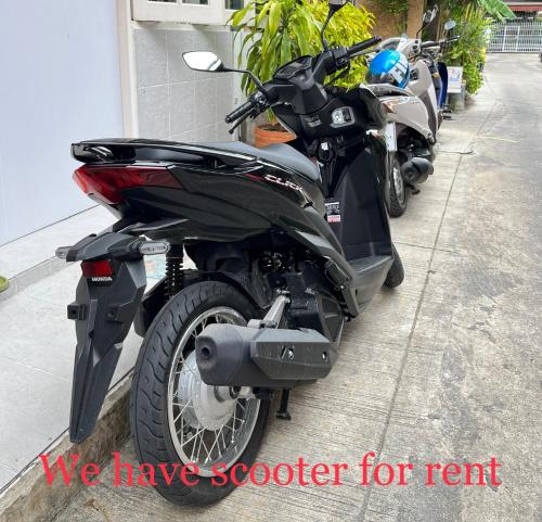 a motorcycle parked on the side of a street at C U Again in Bangkok