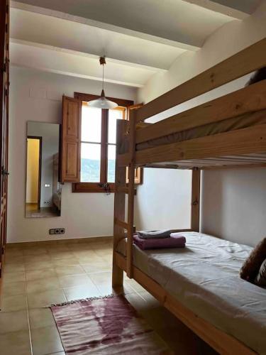 a bedroom with two bunk beds and a mirror at Can Catrol in Santa Cristina d'Aro
