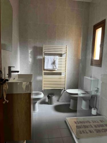 a bathroom with a sink and a toilet and a window at Can Catrol in Santa Cristina d'Aro