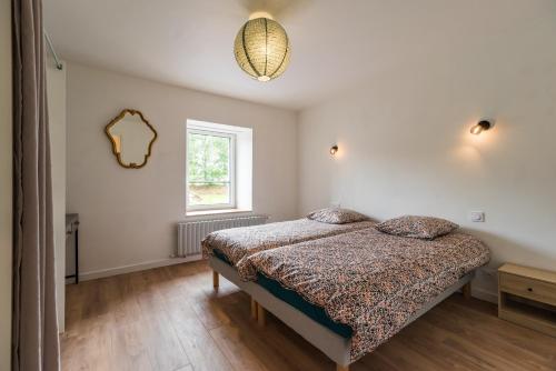 Postel nebo postele na pokoji v ubytování Gîte de Kerduraison - Maison avec grand jardin