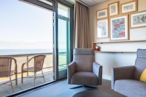 a room with a view of the ocean at Two Brothers Noordwijk Beach in Noordwijk aan Zee