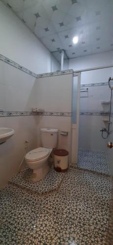 a bathroom with a toilet and a sink at Huynh Lac Can Tho Hotel in Can Tho