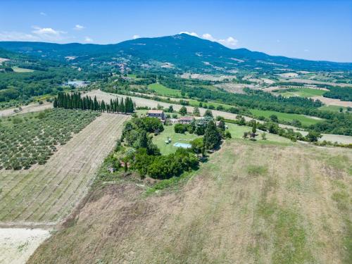 an aerial view of a farm with a field and mountains at Agriturismo Spazzavento in Palazzone