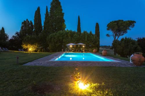 a swimming pool in a yard at night at Agriturismo Spazzavento in Palazzone