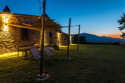 a table and chairs under a tent in a yard at Agriturismo Spazzavento in Palazzone