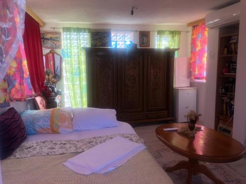 a living room with a bed and a table at U Villi BB2 Gornji Zalik bb in Mostar