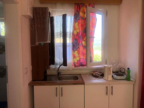a kitchen with a sink and a window at U Villi BB2 Gornji Zalik bb in Mostar