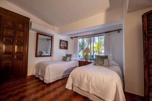 a bedroom with two beds and a window at Rancho Las Cruces in Las Cruces