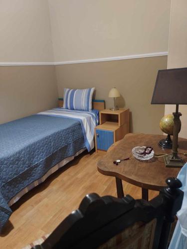 a small bedroom with a bed and a table at Valia's house -Makri Village in Mákri