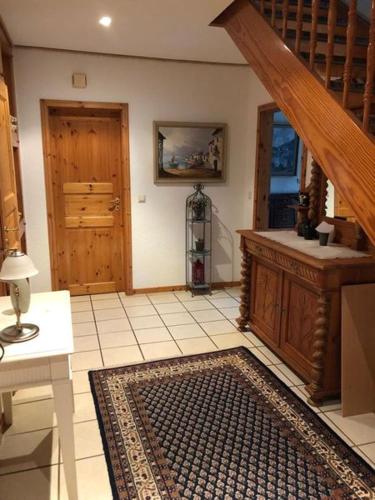 a living room with a staircase and a rug at Ferienhaus Gartower See in Gartow