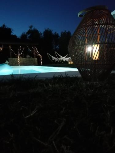 a night view of a pool with a light at Casale I Tigli in Lucca
