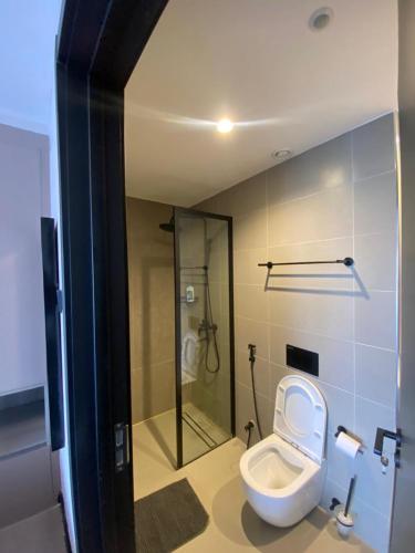 a bathroom with a toilet and a glass shower at Escada in Nairobi