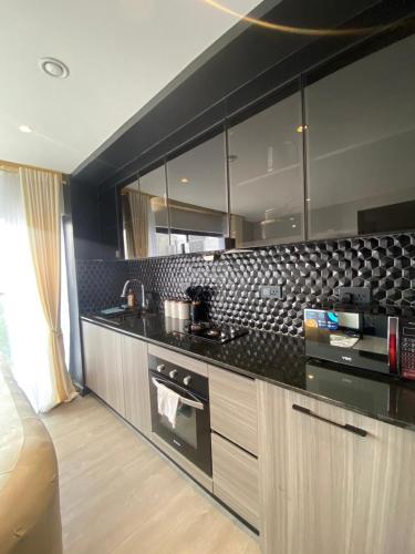 a kitchen with black and white tile on the wall at Escada in Nairobi