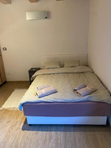 a bedroom with a bed with two pillows on it at Posestvo Tmžek in Bovec