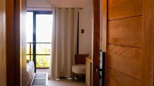 ein Schlafzimmer mit einem Bett und eine Tür mit einem Fenster in der Unterkunft 89 Villas in El Nido