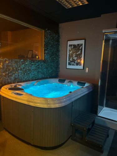 uma grande banheira de hidromassagem num quarto em Privespa hotel Little escape em Wormer