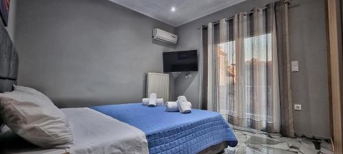 a bedroom with a bed with two teddy bears on it at Mimarxos Luxury Apartments in Chalkida