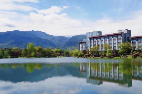 a rendering of a building next to a lake at Le Meridien Emei Mountain Resort in Emeishan