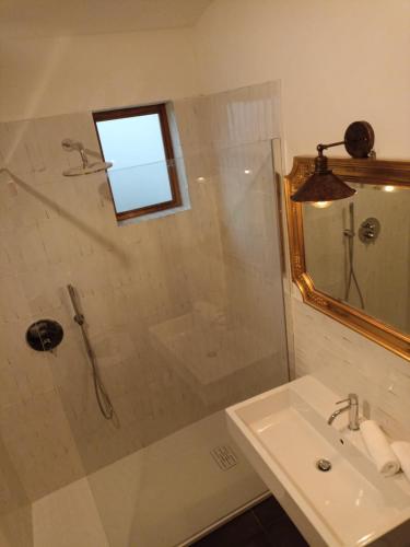 a bathroom with a shower and a sink and a mirror at BB Orvieto in Orvieto