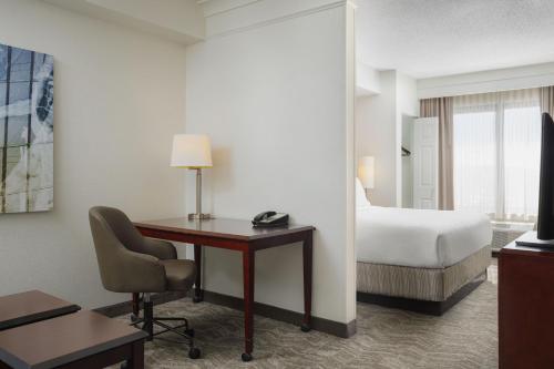 a hotel room with a desk and a bed at SpringHill Suites Knoxville At Turkey Creek in Knoxville