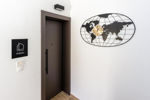a door to a room with a clock on the wall at Pap's Lab Apartments in Heraklio Town