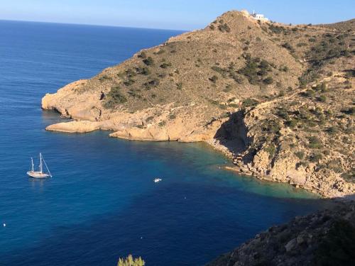 a boat in the water next to a island at Sunylife in Albir