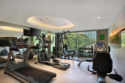 a gym with several treadmills and elliptical machines at SenS Hotel and Spa in Ubud