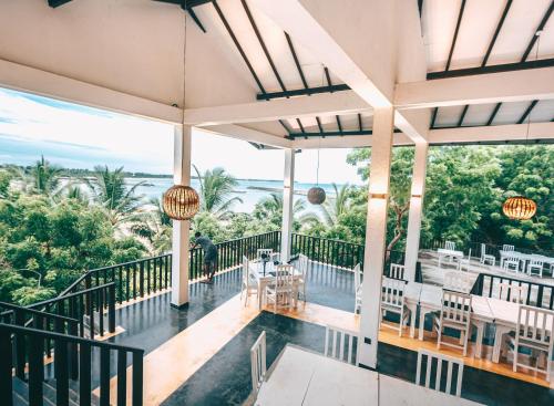 a view of the lobby of a house with tables and chairs at Samudra Beach Resort in Tangalle