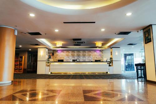 a lobby with a large piano in a building at Hotel Sentral Riverview Melaka in Melaka