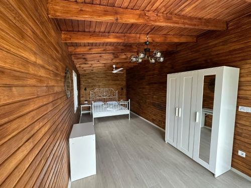 a room with a wooden ceiling with a bed in it at Ovacık Villa Bungalows Çeşme in Çeşme