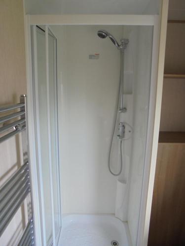 a shower stall in a bathroom with a toilet at Kingfisher : Horizon II:- 8 Berth, Close to site entrance in Ingoldmells