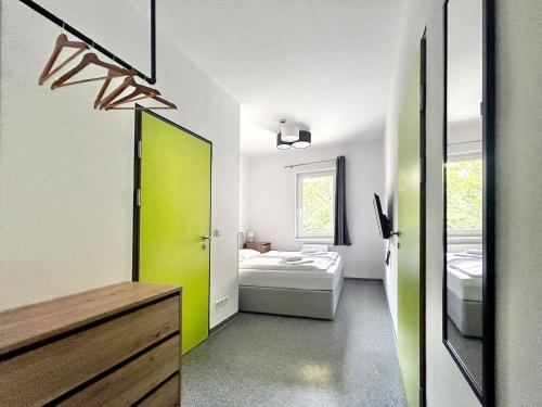 a bathroom with a green door and a bedroom at Hotel Astral Vienna in Vienna