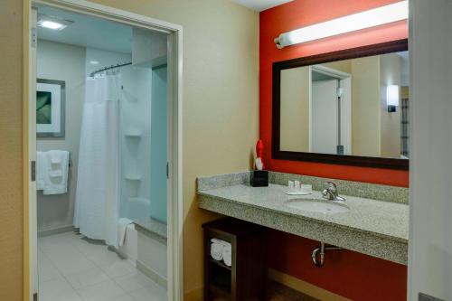 a bathroom with a sink and a mirror at Courtyard by Marriott Indianapolis Noblesville in Noblesville