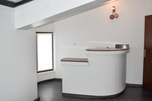 a white kitchen with a counter and a window at Casafamiglia in Prolesha