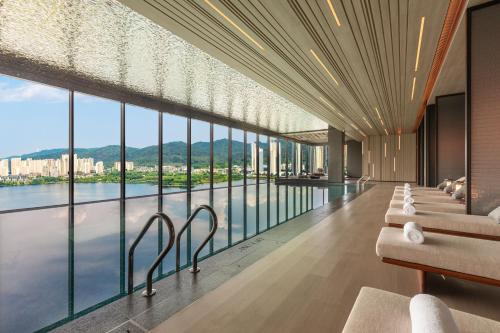 a hotel lobby with a view of the water at Hotel Indigo Changsha Meixi Lake in Changsha