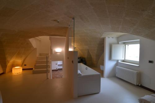 a bathroom with a sink and a tub in a room at Antica Civita Luxury Room in Matera