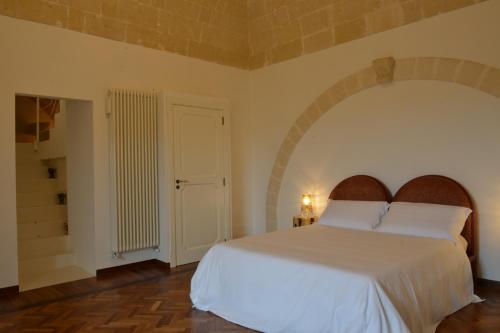 a bedroom with a large white bed in a room at Antica Civita Luxury Room in Matera